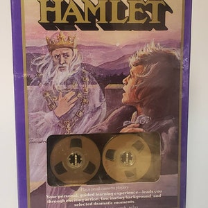 May include: A purple box with a gold title that reads "Cliffs Cassettes Companion to Shakespeare's Hamlet". The box features an illustration of a king and a young man. Two gold cassette tapes are visible in the bottom center of the box.