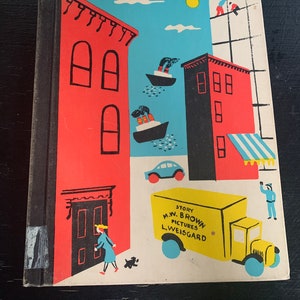 May include: A vintage children's book cover with a red, yellow, and blue illustration of a city scene. The book title is "Story M.W. Brown Pictures Lweisgard".