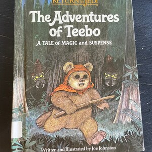 May include: A book cover featuring a brown Ewok character named Teebo from the Star Wars movie Return of the Jedi. The book title is "The Adventures of Teebo" and the subtitle is "A Tale of Magic and Suspense". The book is written and illustrated by Joe Johnston.