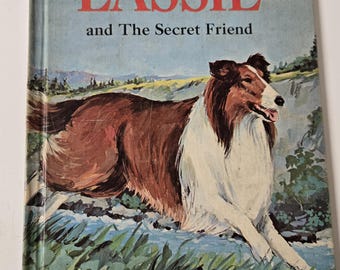 May include: A vintage book cover featuring a brown and white Collie dog running through a grassy field. The title of the book is "Lassie and The Secret Friend".