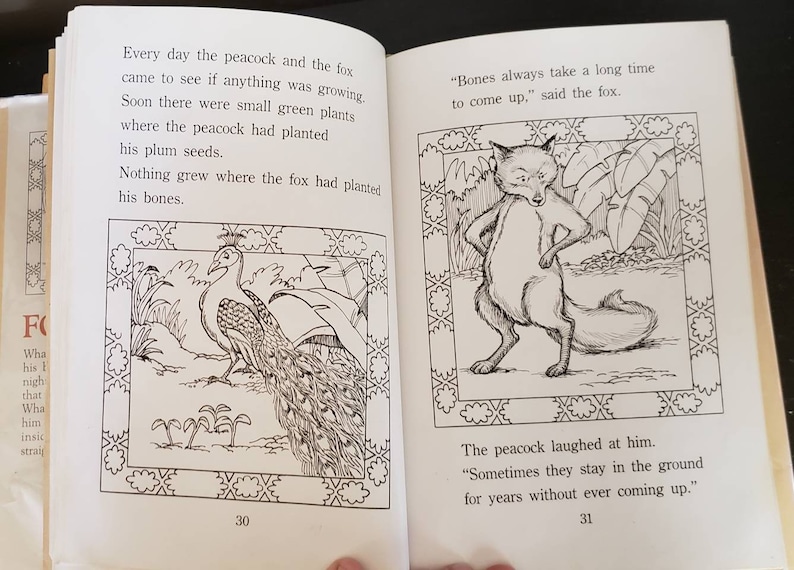 May include: A black and white illustration of a peacock and a fox. The peacock is standing on the ground with its tail feathers spread out. The fox is standing on its hind legs with its paws on its hips. The text "Bones always take a long time to come up," said the fox." is written below the fox.