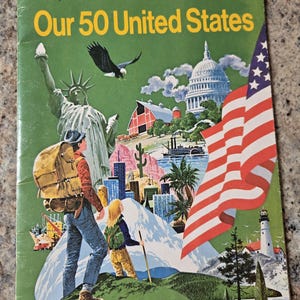 May include: A vintage softcover book titled Our 50 United States, A Golden Exploring Earth Book. The green cover features a collage illustration of the Statue of Liberty, a bald eagle, the U.S. Capitol, a red barn, a lighthouse, and a large U.S. flag.