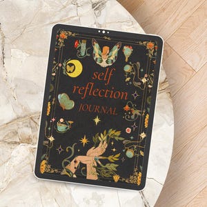May include: A black tablet with a self reflection journal cover. The cover features a fairy with wings, a moon, stars, and flowers. The text on the cover reads "self reflection journal".