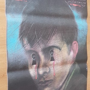 May include: A vintage film poster for "Krotki Film o Milosci" (A Short Film About Love). The poster shows a young person with keyhole eyes and tears. The title is in red, with the director and cast listed on a dark background.