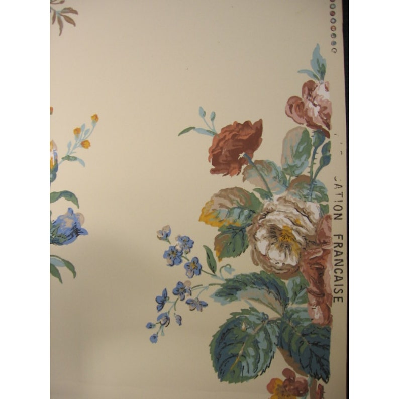 May include: Vintage floral wallpaper with a cream background and a border of blue, green, and brown flowers. The text "JATION FRANCAISE" is printed on the right side of the border.