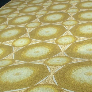 May include: A repeating pattern of overlapping circles in shades of brown and white on a wallpaper.
