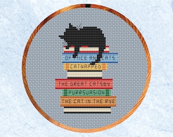 May include: A black cat sitting on top of a stack of books with titles referencing famous books. The titles are "Of Mice and Cats", "Catnapped", "The Great Gatsby", "Purrsuasion", and "The Cat in the Rye".