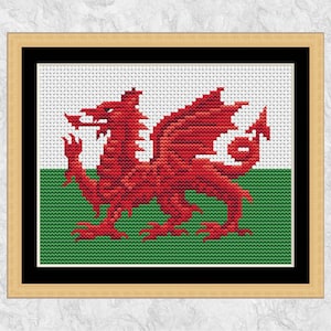 Puede incluir: Un punto de cruz enmarcado de la bandera galesa, con un dragón rojo sobre un fondo verde y blanco.