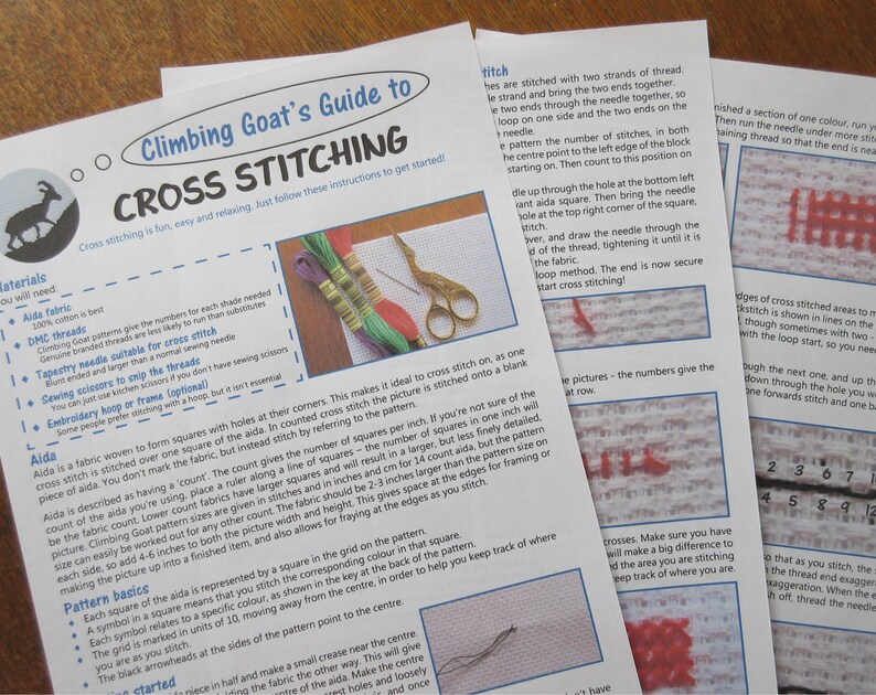 May include: A close-up of a guide to cross stitching with a colorful goat illustration and instructions on how to cross stitch. The guide includes information on materials, basic patterns, and stitching techniques.