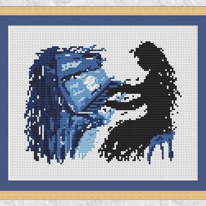 May include: Cross-stitch pattern of a blue and white portrait of a man with a beard and a black silhouette of a woman behind him.