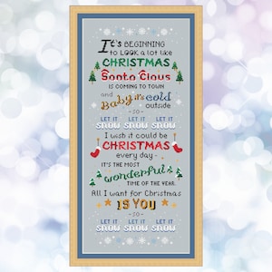 May include: A cross-stitch pattern with a blue background and white snowflakes. The text reads "It's beginning to look a lot like Christmas. Santa Claus is coming to town and baby it's cold outside. Let it snow, let it snow, let it snow. I wish it could be Christmas every day. It's the most wonderful time of the year. All I want for Christmas is you. Let it snow, let it snow, let it snow."