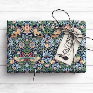 May include: A blue and green patterned gift wrap with a floral and bird design. The wrapping paper is tied with a black and white twine bow and a tag that reads "Paperlust, Perfect Paper, Printed & Designed in Melbourne".