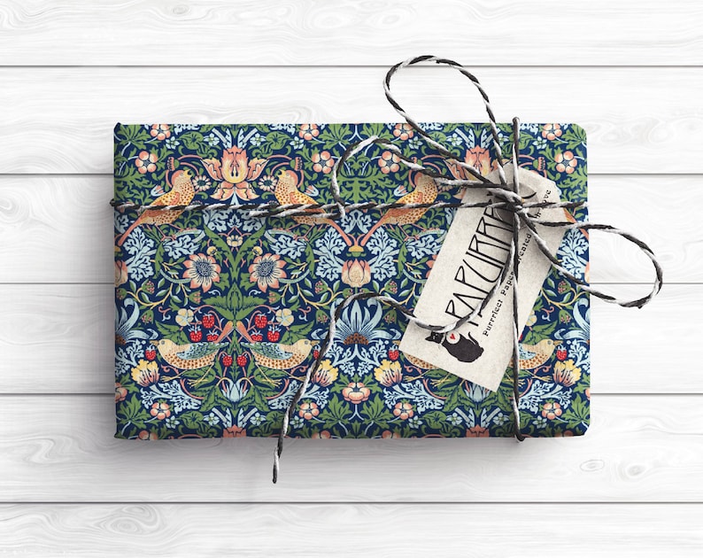 May include: A blue and green patterned gift wrap with a floral and bird design. The wrapping paper is tied with a black and white twine bow and a tag that reads "Paperlust, Perfect Paper, Printed & Designed in Melbourne".
