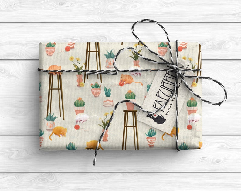 May include: A gift wrapped in brown paper with a cat and plant pattern. The paper is tied with twine and a tag that reads "Purrfect Paper" with a cat illustration.