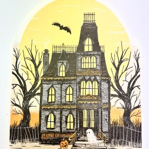 May include: A black and white illustration of a spooky house with a ghost in front of it. The house has a yellow glow and a bat flying overhead. There is a jack-o-lantern on the steps.