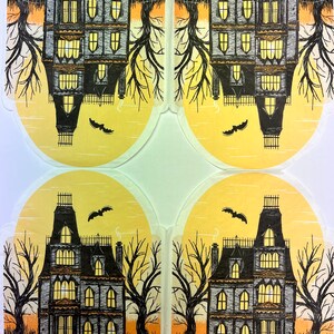 May include: Four illustrations of a spooky, dark gray Victorian house with yellow windows, a white ghost, and a jack-o-lantern on the porch. The house is surrounded by bare trees and a black fence. The background is a yellow sunset.