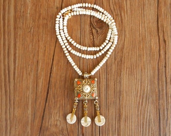 Long ethnic necklace with precious Tibetan pendant and string of white howlite stones