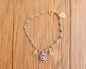 Bracelet with EvilEye (lucky amulets) on gold-plated brass chain and charms