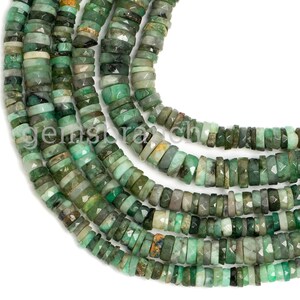 May include: A strand of emerald green gemstone beads, each bead is faceted and has a slightly irregular shape. The beads are strung together to form a long necklace.