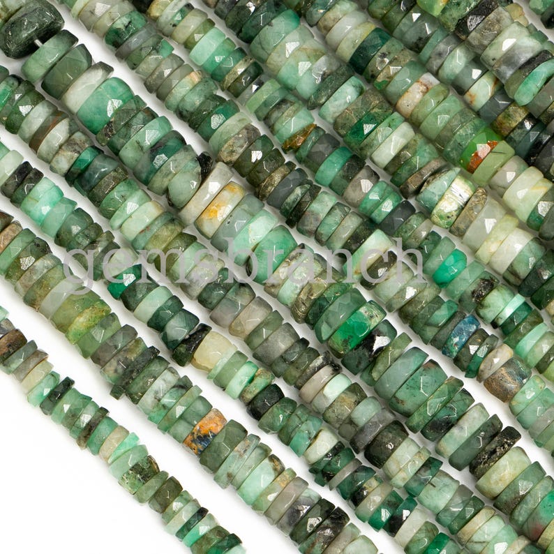 May include: A strand of emerald green gemstone beads, each bead is faceted and has a unique shape. The beads are arranged in rows, creating a textured and visually appealing pattern.