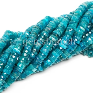 May include: A strand of teal blue gemstone beads, faceted and shaped like small, elongated squares. The beads are strung together to create a long necklace or bracelet.