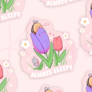 May include: A sticker featuring a cartoon bee sleeping in a purple tulip with the text "Always Sleepy". The sticker is surrounded by pink and white flowers.