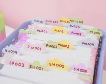 May include: A close-up of a blue plastic file holder with colorful cloud-shaped tabs. The tabs are labeled with numbers and letters, such as "SH004", "SP003", "PW001", "PL001", and "PL002".