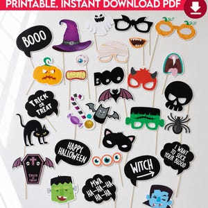 May include: A collection of printable Halloween photo booth props on sticks, featuring various designs including a purple witch hat, orange pumpkins, black bats, a skull, a coffin, a spider, and speech bubbles with text like BOOO and TRICK OR TREAT.
