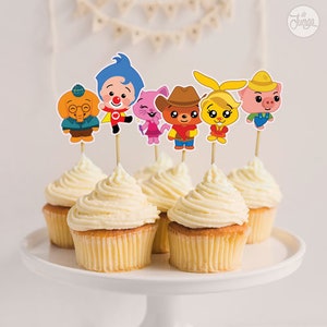 Puede incluir: Conjunto de 6 adornos para cupcakes coloridos con personajes del programa infantil "The Backyardigans". Los adornos incluyen a Uniqua, Pablo, Tyrone, Tasha y Austin.