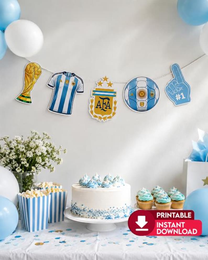 May include: A party banner featuring cutouts of a gold trophy, a blue and white striped soccer jersey, the AFA crest, a soccer ball, and a blue foam finger. The banner hangs above a white cake, blue and white striped popcorn boxes, and balloons.