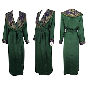 May include: A long, emerald green robe with a V-neck and long sleeves. The collar and cuffs are adorned with gold, purple, and green embellishments. A matching belt cinches the waist. The robe is displayed from multiple angles.