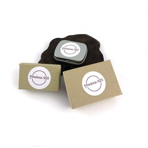 May include: Three boxes with the text "Precious 925" on them. Two of the boxes are brown cardboard and one is a silver metal box.