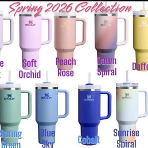 May include: Collection of Stanley tumblers in various colors, including purple, peach, and blue. Each tumbler has a handle, a straw, and the Stanley logo. The text "Spring 2026 Collection" is at the top.