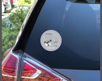 May include: A circular white sticker applied to a car window featuring the runDisney Springtime Surprise Weekend 2027 logo. The design includes black graphics of Mickey Mouse, musical notes, film strips, and the Walt Disney World logo.
