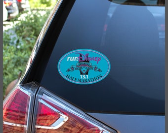 May include: A blue oval sticker with the text "runDisney" in white and pink lettering. The sticker also features a smaller image of a wine glass and the text "Disney Wine & Dine Half Marathon 13.1".