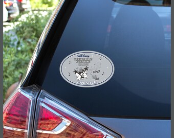 May include: An oval-shaped car decal featuring the text runDisney SPRINGTIME SURPRISE CHALLENGE, 2027, 19.3 MI, and FINISHER. The design includes a black and white graphic of Mickey Mouse, musical notes, and stars on a light gray background.