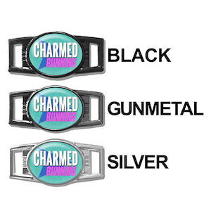 May include: Three shoe charms with the text "CHARMED RUNNING" in pink and white on a turquoise background. The charms are shown in three different finishes: black, gunmetal, and silver.