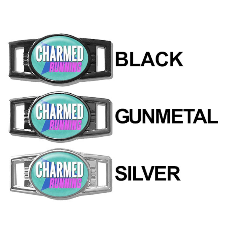 May include: Three shoe charms with the text "CHARMED RUNNING" in pink and white on a turquoise background. The charms are shown in three different finishes: black, gunmetal, and silver.
