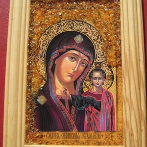 New Orthodox miraculous icon of the Mother of God of Kazan with amber chips on a wooden frame