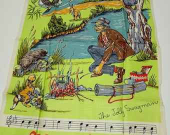 May include: A vintage linen tea towel with a colorful illustration of an Australian bush scene. The design features a man by a campfire, wildlife, and musical notes. The text "Waltzing Matilda" and "The Jolly Swagman" are visible.