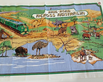 May include: A colorful map of Australia with a green train, camel, kangaroo, and other animals. The text "RAIL-ROAD ACROSS AUSTRALIA" is displayed across the top. The map is hand printed.