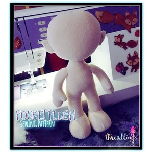 May include: A white plush toy sewing pattern for a pocket plush. The pattern is called "Pocket Plush Sewing Pattern".