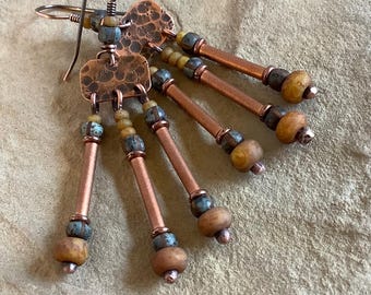 May include: Copper earrings with a hammered copper charm and blue and yellow beads.