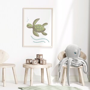 A framed illustration of a sea turtle in a wooden frame on the wall in a child’s playroom with toys