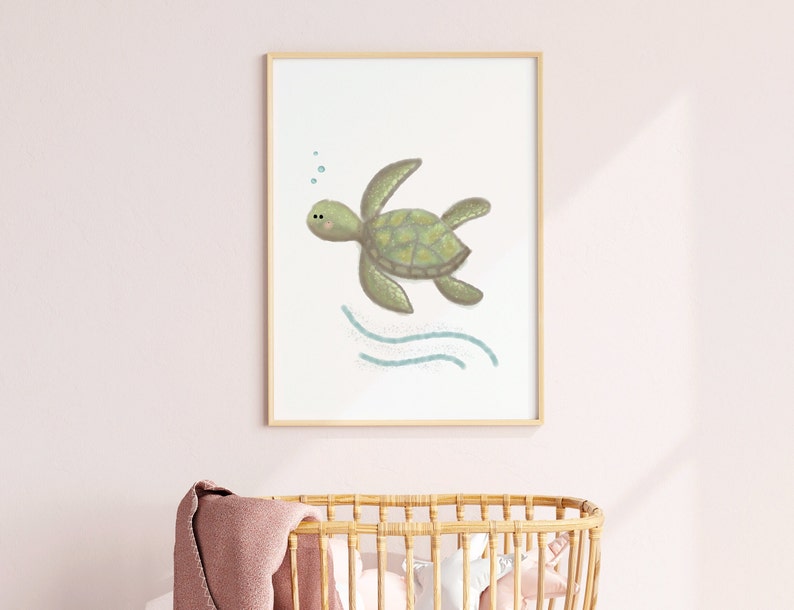 Illustration of sea turtle nursery art in a wood frame hung on a pink wall in a nursery