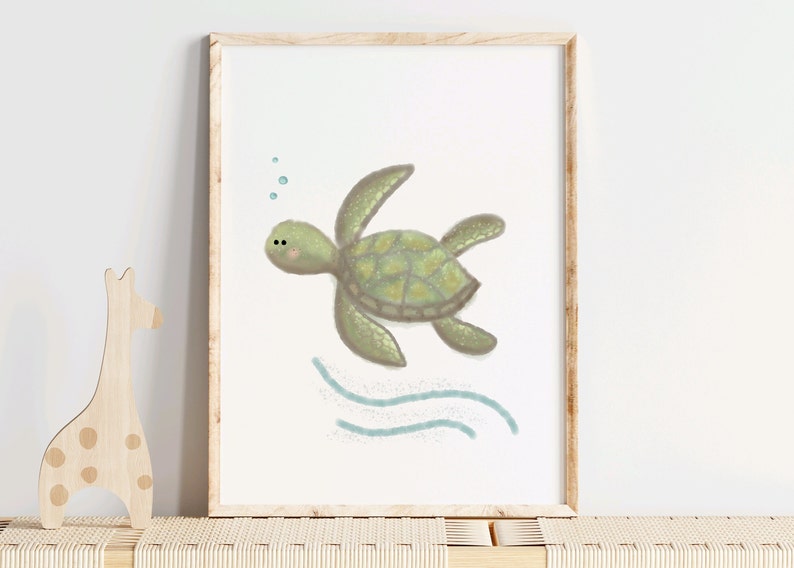 Illustration of sea turtle nursery art in a wood frame sitting on a wood shelf in a nursery