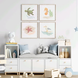 4 illustrations of sea turtle, sea horse, star fish, and seagull a wood frames hung on a wall in a children’s play room with toys