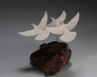 Dove trio Sculpture by John Perry 6 inches high on burlwood base.