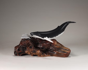 Humpback Whale with Dolphins sculpture by John Perry on polished burlwood base. Signed.
