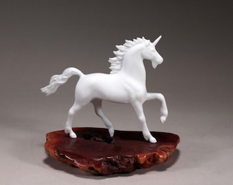 Unicorn Sculpture by John Perry 8in long on burlwood slab Signed.